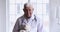 Smiling old male pediatrician hold teddy bear looking at camera