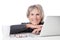 Smiling old woman behind laptop