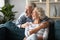 Smiling older couple dreaming together, looking out window