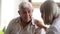 Smiling older patient listening to caring mature doctor close up