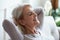 Smiling older woman relaxing with hands behind head