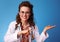 Smiling paediatrician woman pointing on something on empty palm