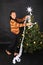 Smiling Papuan girl putting white paper chain on Christmas tree