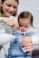 Smiling parent pouring milk from jug