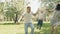 Smiling parents holding up cute son in summer park. Family have fun outdoors