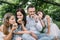 Smiling parents with two kids eating cupcakes on picnic