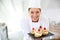 Smiling pastry chef with deserts