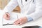 Smiling pediatrician sitting at table