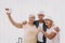 Smiling Pensioners Taking Selfie in Waiting Room.