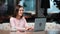 Smiling pensive freelancer woman working remotely use laptop at cafeteria. 4k Dragon RED camera