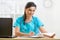 Smiling physician working in her office