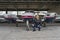 Smiling Pilot in front of Modern Private Airplane in a Hangar