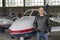 Smiling Pilot in front of Small Airplane in a Hangar