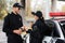 Smiling police officer holding takeaway coffee