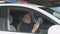 Smiling policeman in patrol car chatting on smartphone, social network addiction