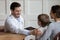 Smiling positive gp pediatrician stroking shoulder of little boy patient.