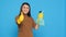 Smiling positive housekeeper holding chemical detergent spray doing approval gesture