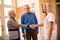 Smiling positive nurse shake hands with new patients at clinic