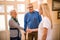 Smiling positive nurse shake hands with new patients at clinic