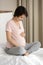 Smiling pregnant woman touch caress baby bump