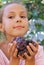 Smiling preteen girl with grapes