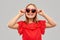 Smiling preteen girl with heart shaped sunglasses