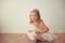 Smiling pretty ballet girl in white tutu in studio