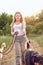Smiling pretty blond woman walking her two dogs