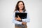 Smiling pretty european young lady professional teacher hugs laptop with empty space