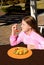 Smiling pretty girl eating healthy fruit salad outdoors.