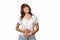 A smiling pretty woman in casual clothes holds her stomach with hands. White background. Concept of good digestion and helthy