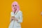 smiling pretty woman pink wig suit phone technology