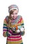 Smiling pretty young girl wearing coloful knitted scarf, hat and mittens, holding christmas gift isolated.