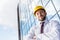 Smiling professional architect in hard hat against building