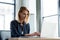 smiling professional businesswoman working with laptop