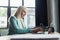 Smiling psychologist using laptop in consultation