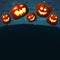 Smiling pumpkins jumping on a grass. Spooky dark blue background