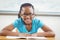 Smiling pupil reading book in a classroom