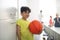 Smiling pupil standing near lockers in changing room.