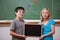 Smiling pupils holding a school slate