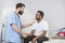 Smiling Radiologist And Patient Shaking Hands After CT Scan