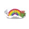 Smiling rainbow cartoon character having a green gift box