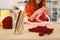 Smiling red-haired girl sitting near crochet sticks