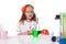 Smiling red-haired schoolgirl posing in lab