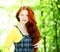 Smiling redhaired girl, outdoors