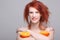 Smiling redhaired woman with orange half