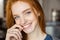 Smiling redhead woman looking at camera