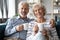 Smiling retired family spouses enjoying lazy weekend morning time.