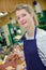 Smiling sales woman working at counter in fish store