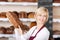 Smiling salesgirl holding bread